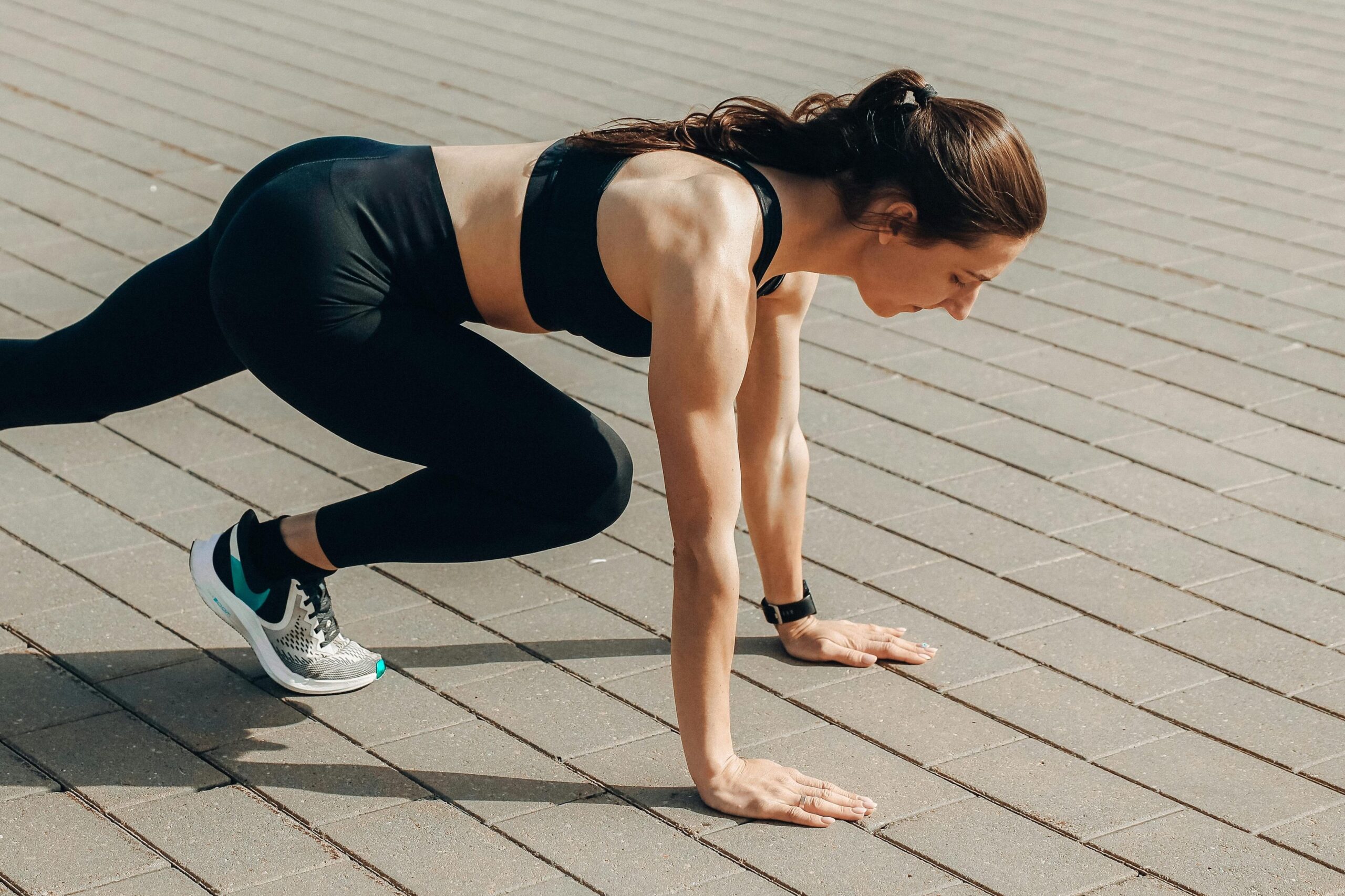 pexels-photo-4775202-4775202 Woman in black sportswear doing an outdoor workout on a sunny day.